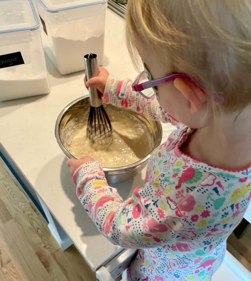 Toddler Making Pancake Batter for eating before riding our bike.